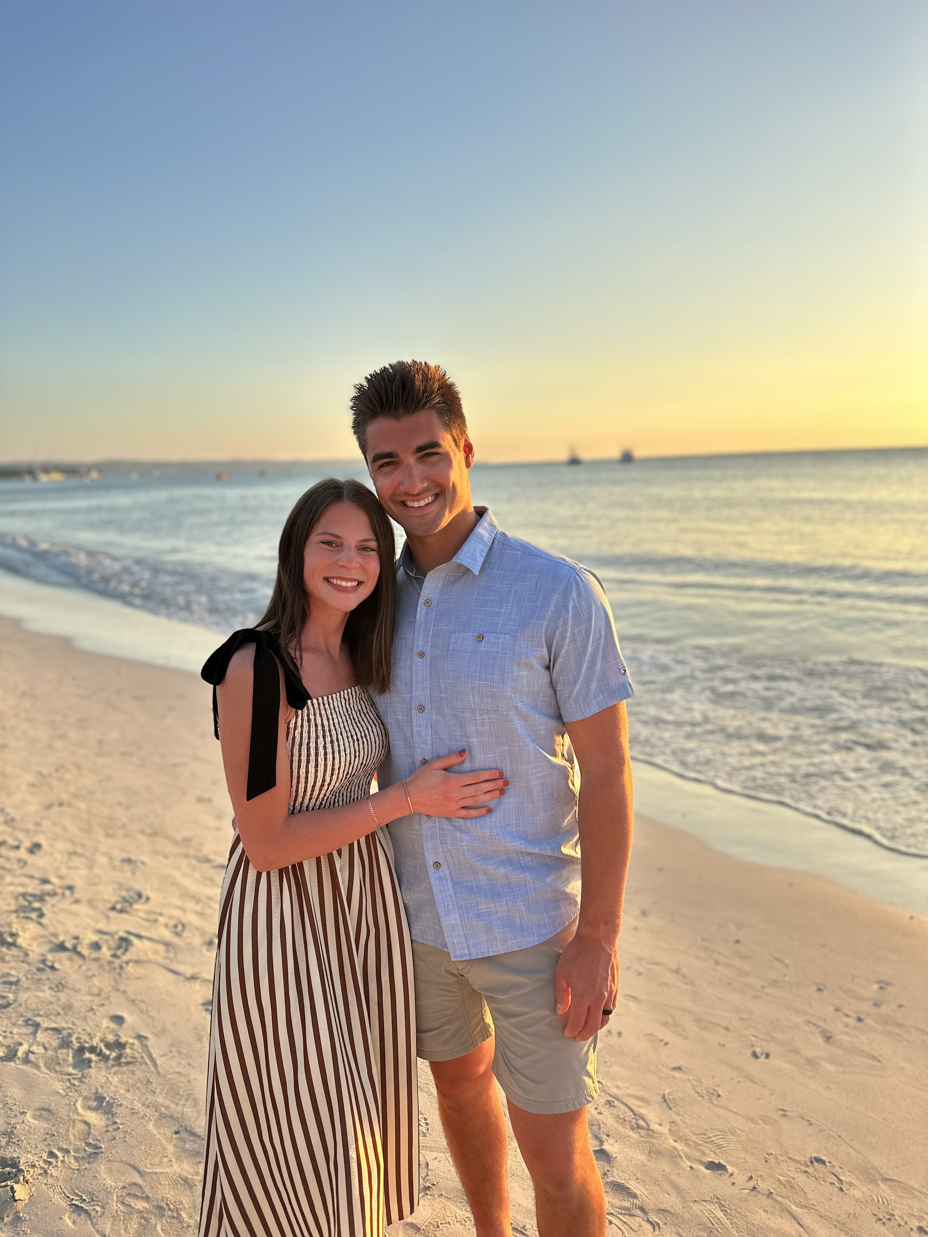 Sydney and her husband on the beach at sunset